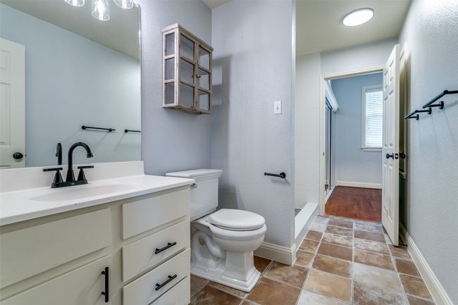 Bathroom featuring vanity, a shower stall, and stone finish flooring | Image 19