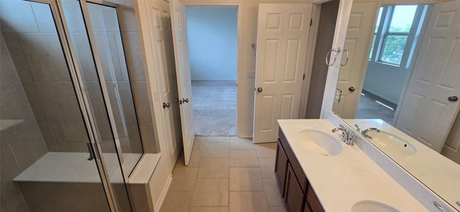 Full bath with double vanity, a stall shower, and tile patterned flooring | Image 20