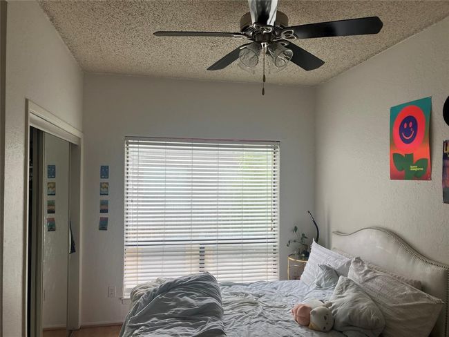 Bedroom featuring a textured ceiling and ceiling fan | Image 10