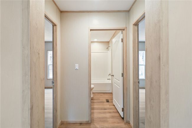 Corridor with visible vents and light wood-type flooring | Image 12