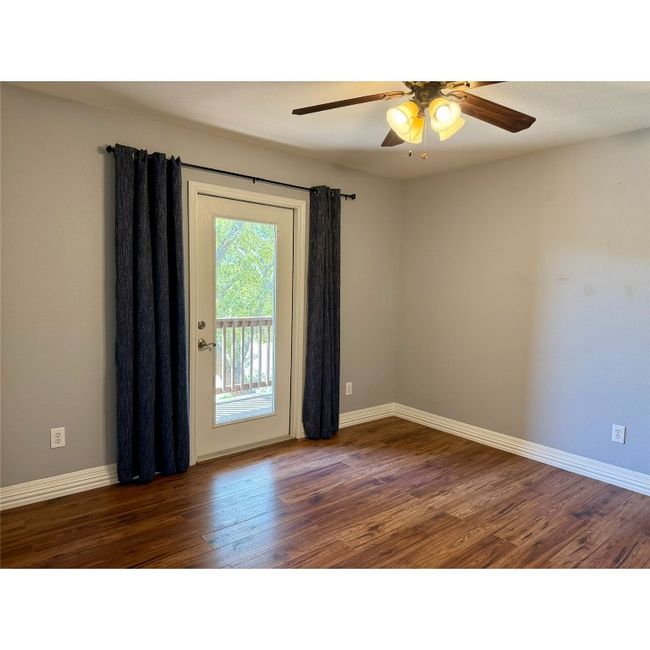 Bedroom two has a private exit onto the upper level deck on the front on the house. This room can be used as a bedroom, home office or other uses(this room does not have a closet) | Image 31