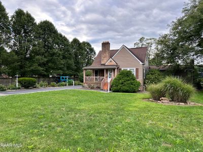 This Cape cod homes sit on .55 of a level acre. | Image 2