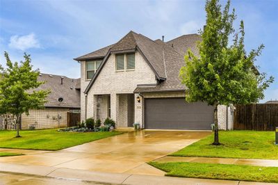 View of front of home with a front lawn and a garage | Image 3