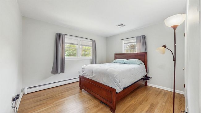Bedroom with large closets and hardwood flooring. | Image 18