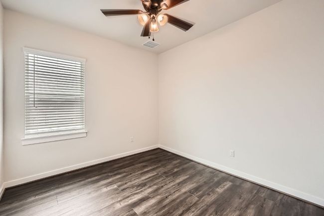 Unfurnished room with a ceiling fan, dark wood-type flooring, and baseboards | Image 25