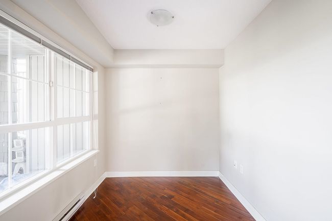 Spare room with a baseboard radiator, dark wood-style flooring, and baseboards | Image 19