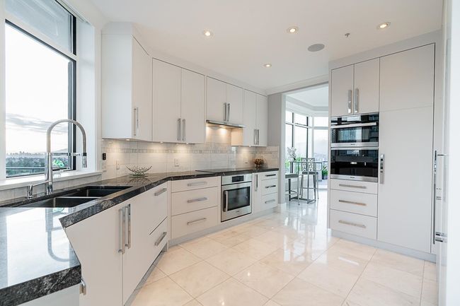 Kitchen featuring a sink, healthy amount of natural light, tasteful backsplash, light tile patterned floors, and recessed lighting | Image 25