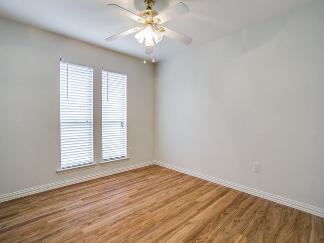 Spare room featuring light wood-style floors, baseboards, and a ceiling fan | Image 15