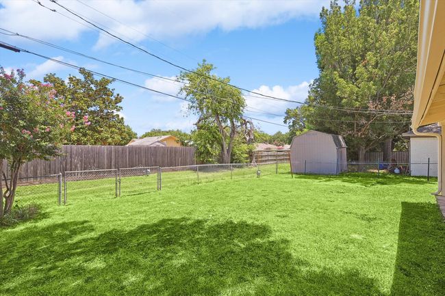 View of yard featuring an outbuilding, a shed, and a fenced backyard | Image 34