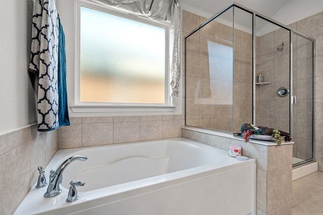 Full bathroom featuring a shower stall, plenty of natural light, a bath, and tile patterned floors | Image 18