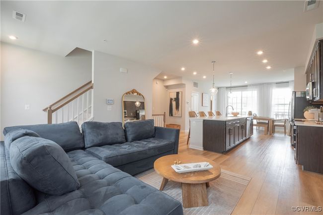 Living room with light wood-type flooring, visible vents, recessed lighting, and stairway | Image 14