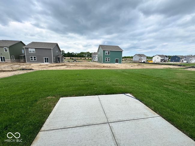 view of green lawn featuring a residential view and a patio area | Image 9