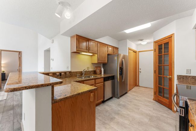 Main level - large kitchen with pantry and stainless appliances | Image 6