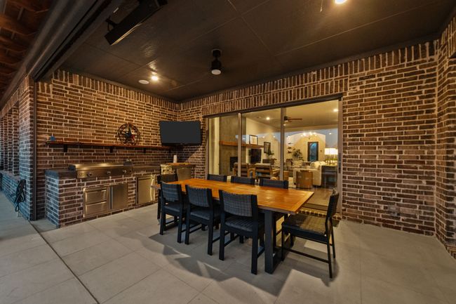 View of back patio featuring an outdoor kitchen, ceiling fan, and breathtaking views | Image 34