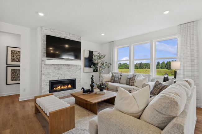 (Photo of a decorated model, actual homes finishes will vary) The family room is the perfect place to relax next to the fire. | Image 6