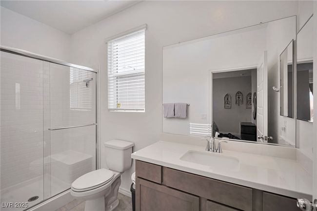 Bathroom with vanity, toilet, and a shower stall | Image 12