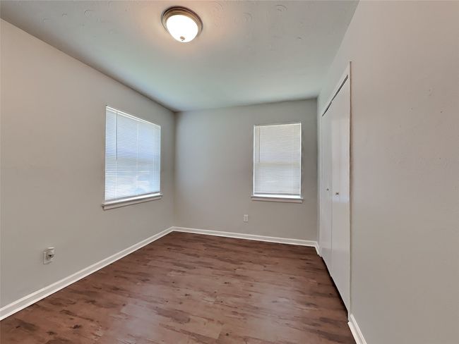 Empty room featuring wood finished floors and baseboards | Image 10