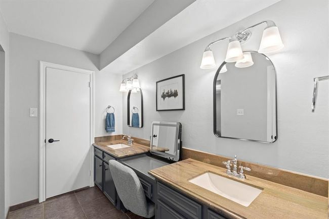 The primary bathroom features a double vanity with stylish mirrors and modern lighting. The neutral palette and ample counter space provide a clean, inviting atmosphere. | Image 19