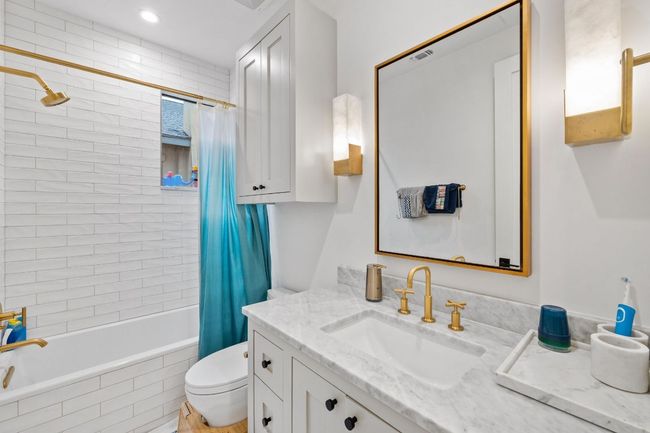 Bathroom featuring vanity, tiled shower / bath, and recessed lighting | Image 24