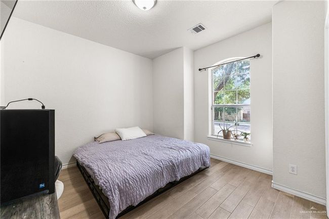 Bedroom with light wood-type flooring and baseboards | Image 33