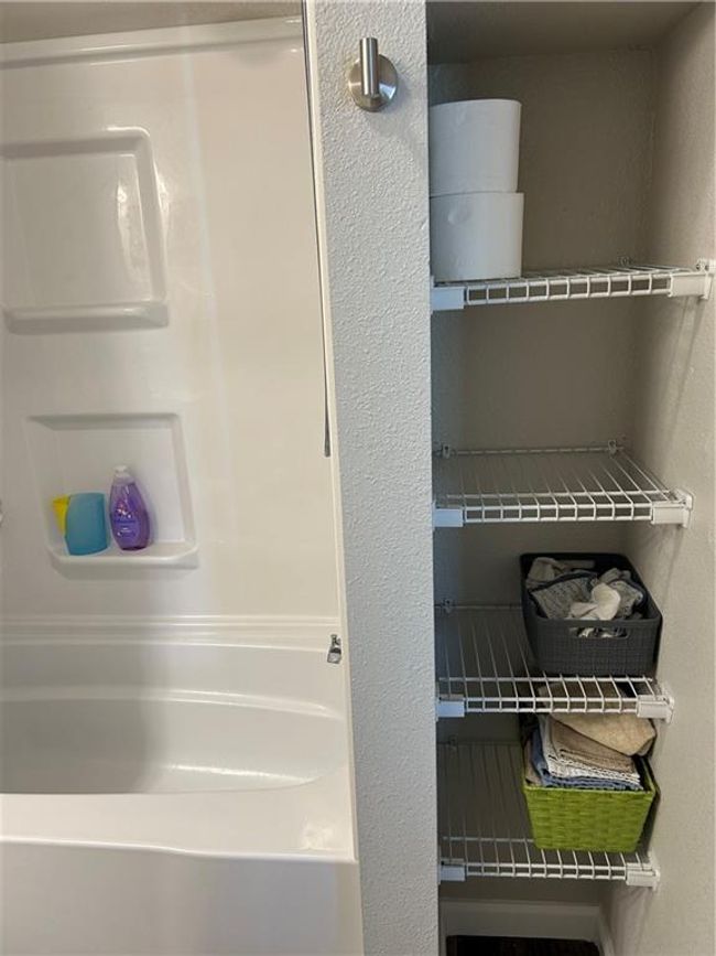 built in shelves next to tub | Image 22
