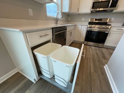 9853 32nd St NE - Kitchen features a trash/recycling pullout convenient to the sink. | Image 3