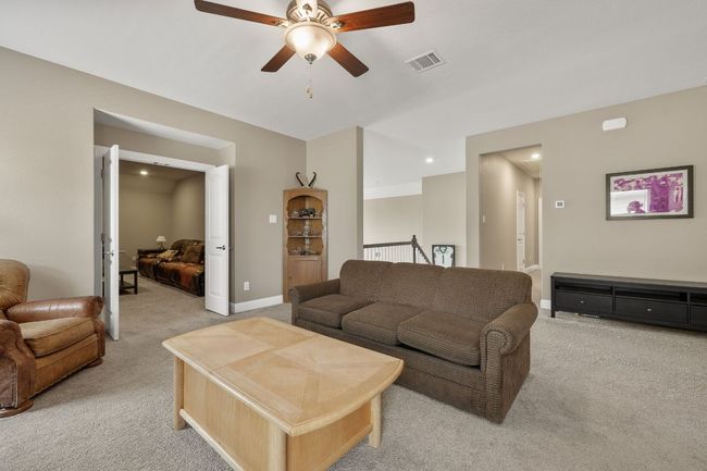 Bonus area at the top of the stairs with light carpet, a ceiling fan, baseboards, and recessed lighting | Image 32