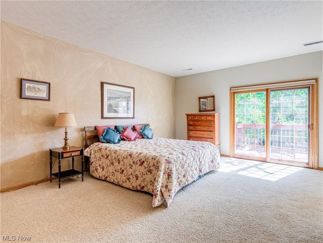Carpeted bedroom featuring a textured ceiling | Image 5