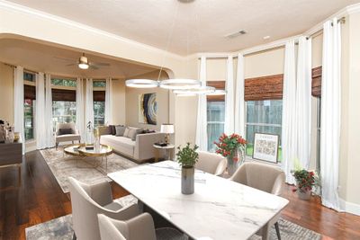 Experience the elegance of this spacious, sunlit dining room with sitting area artfully designed to inspire your future home's potential.*Image shown includes virtual staging to enhance spatial visualization. | Image 2