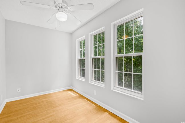 Empty room featuring light wood-style floors and ceiling fan | Image 26