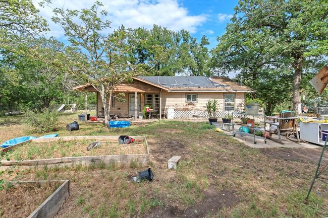 Back of property with a patio, a garden, and solar panels | Image 7