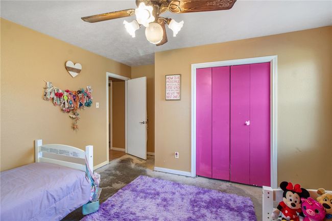 Carpeted bedroom featuring ceiling fan and a closet | Image 28