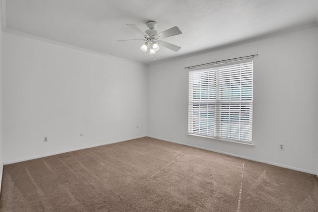 Bedroom featuring carpet flooring, a ceiling fan, and crown molding | Image 19