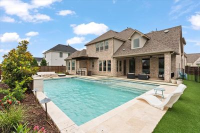 View of pool with a patio area and a lawn | Image 2