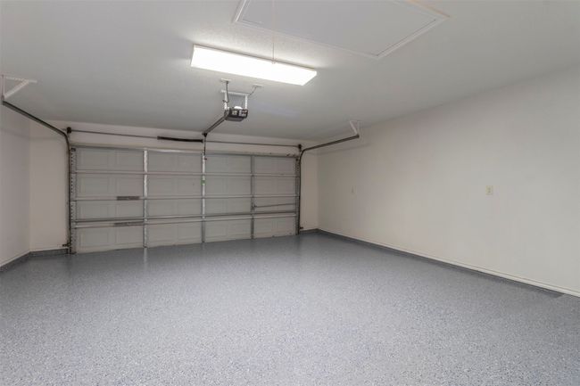Garage with baseboards and a garage door opener | Image 34