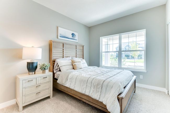Highly sought after on the main level, this bedroom offers the a room for overnight guest. Complete with a private full bath, it is just a perfect addition to the floor plan! Photo of model home, color and options will vary. | Image 5