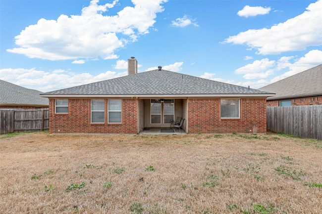 Rear view of property with a yard, brick siding, and a fenced backyard | Image 34