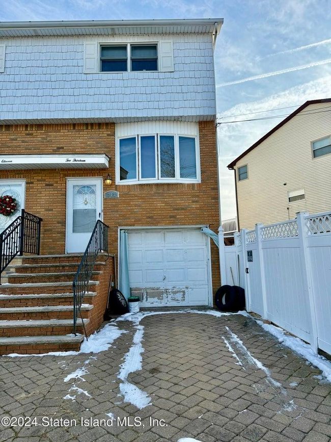View of front facade featuring a garage | Image 9
