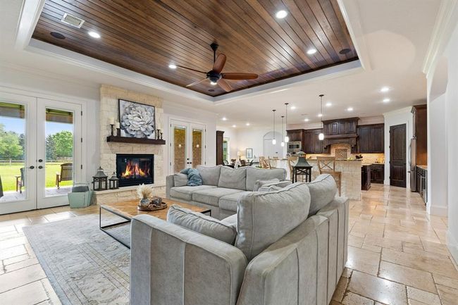 The Living Room and Kitchen feel big and bright thanks to the abundance of natural light that fills the space through the pair of glass-plated double doors on either side of the fireplace, and wall of windows in the Breakfast Room. | Image 13