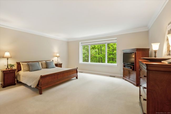 Spacious main level primary bedroom with tons of natural light. | Image 20