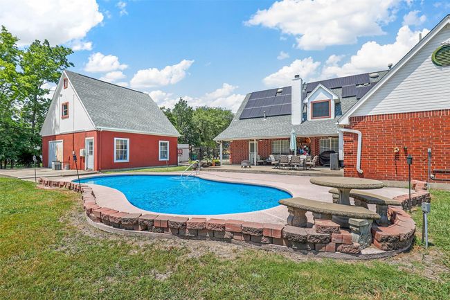 View of pool featuring a patio area and a lawn | Image 8