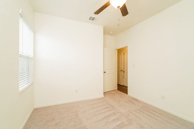 Carpeted spare room with a ceiling fan and baseboards | Image 19