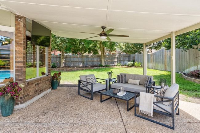 Fenced backyard featuring an outdoor living space, a patio, and a ceiling fan | Image 27