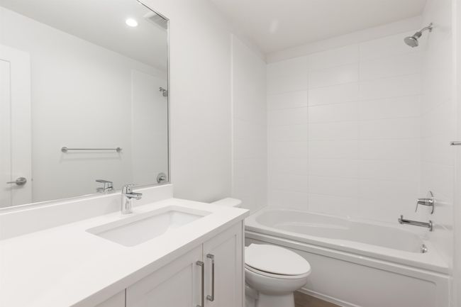 Full bath featuring washtub / shower combination, vanity, and toilet | Image 23