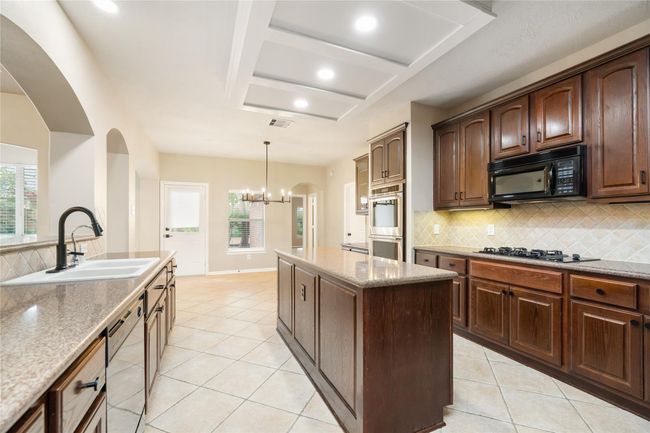 Making it ideal for entertaining and everyday gatherings in a naturally lighted environment. A view from this side of the kitchen offers easy access to the connected dining area. | Image 15