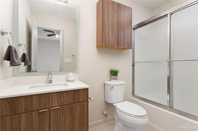 Full bath with vanity and combined bath / shower with glass door | Image 13