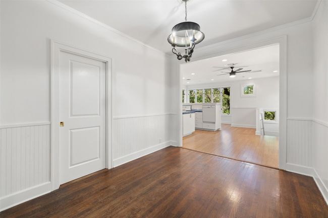 Unfurnished dining area featuring ceiling fan, hardwood / wood-style floors, and wainscoting | Image 6