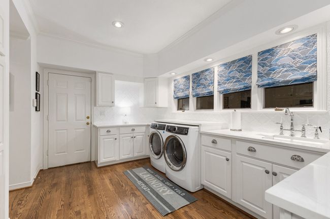 Laundry with quartz counters, hardwoods and windows allowing for natural light | Image 30