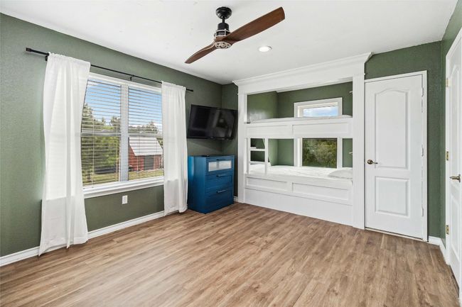 Unfurnished living room featuring baseboards, a ceiling fan, and wood finished floors | Image 23
