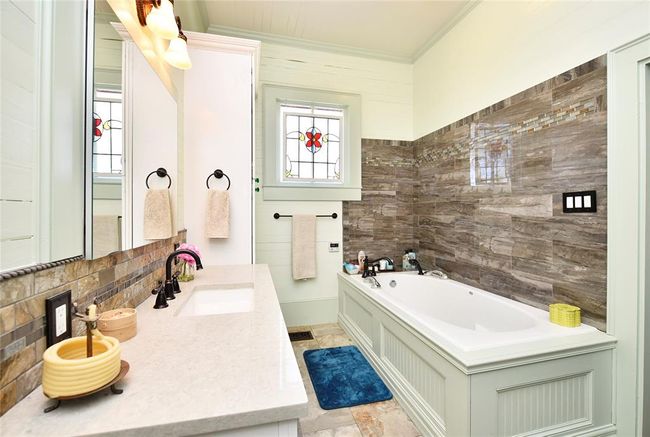 The primary bath has been updated with an air-bubble tub and stand alone shower. | Image 10